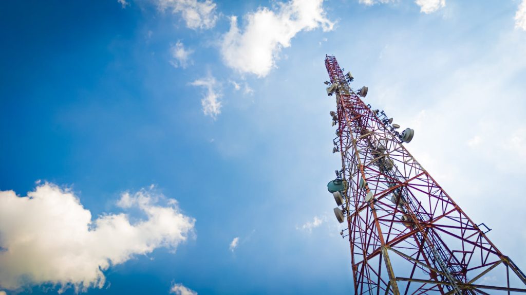 Telecommunication tower under cloudy and blue sky. Wireless communication and information technology 5g tower